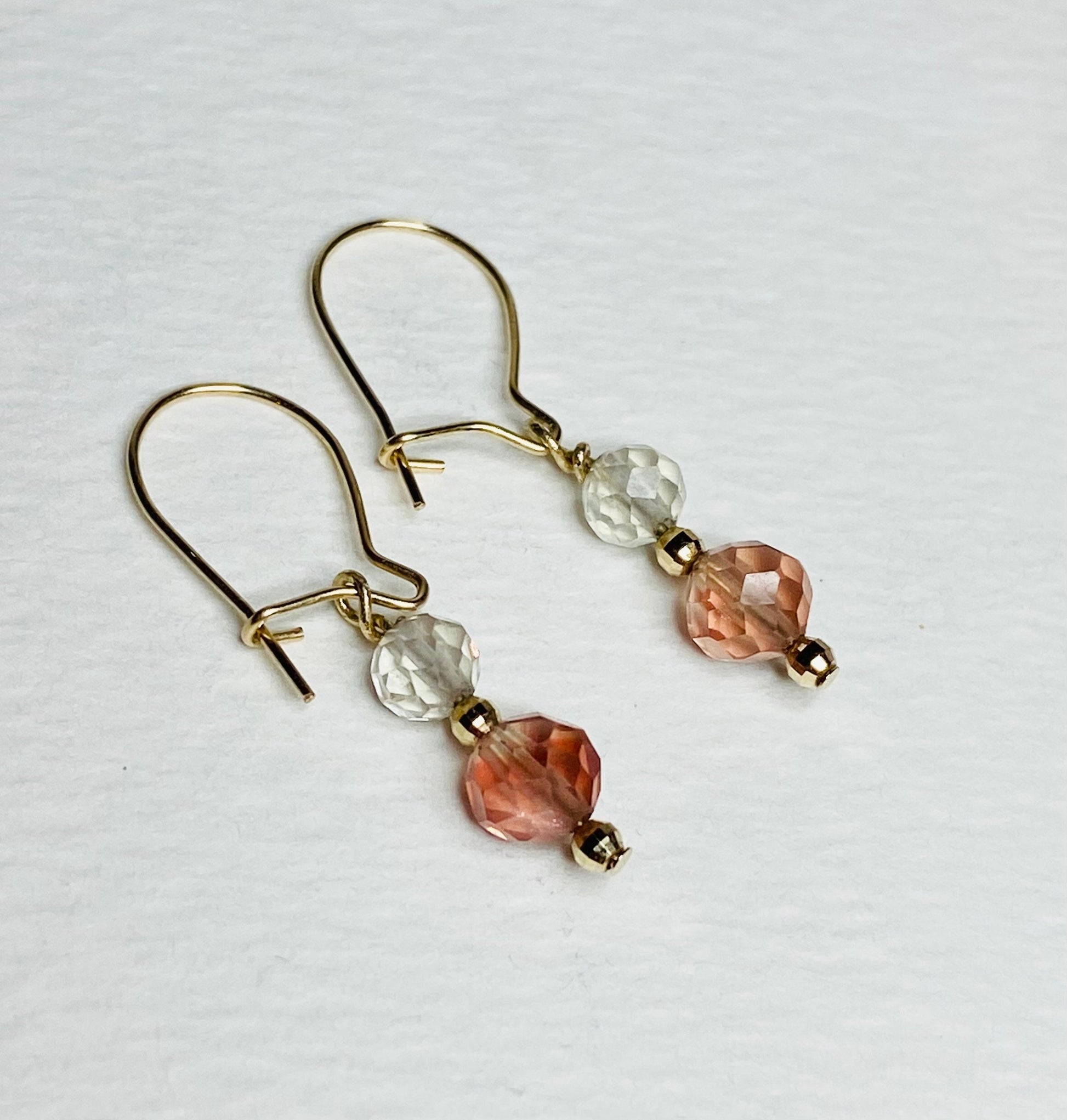 Solid 14k gold dangle earrings with faceted Oregon Sunstone beads.