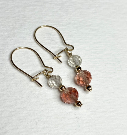 Solid 14k gold dangle earrings with faceted clear and pink Oregon Sunstone beads.