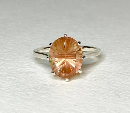 Sterling silver ring with a large oval, peach-colored Oregon sunstone.