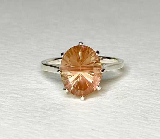 Sterling silver ring with a large oval, peach-colored Oregon sunstone.