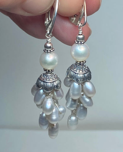 Silver dangle earrings with white freshwater pearls and lever backs.