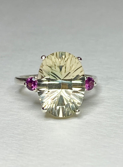 Sterling silver ring with a large oval Oregon sunstone and two round Idaho rhodolite garnets.