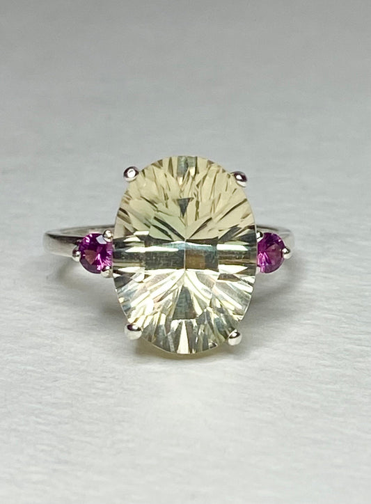 Sterling silver ring with a large oval Oregon sunstone and two round Idaho rhodolite garnets.