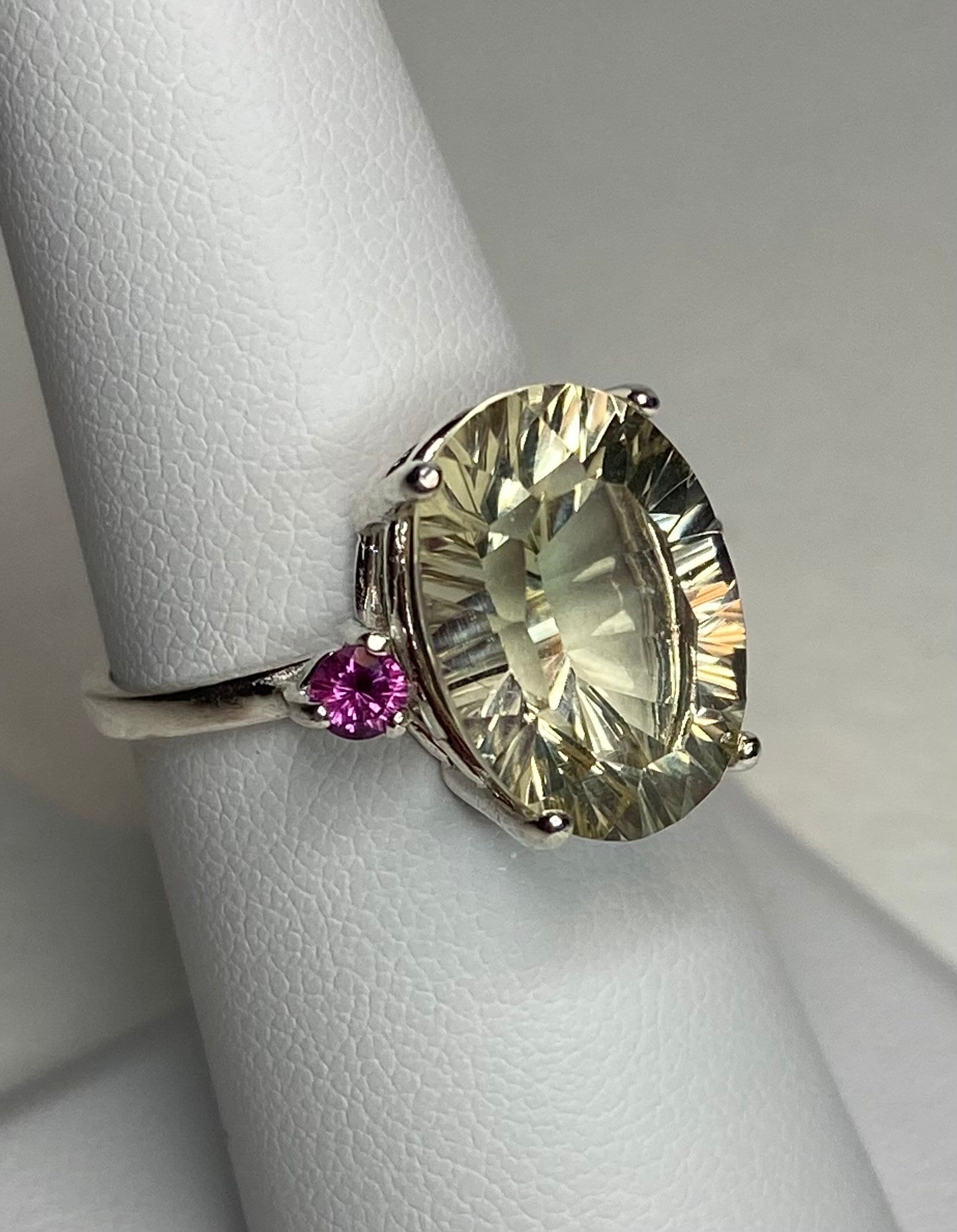 Sterling silver ring with a large oval Oregon sunstone and two rhodolite garnets.