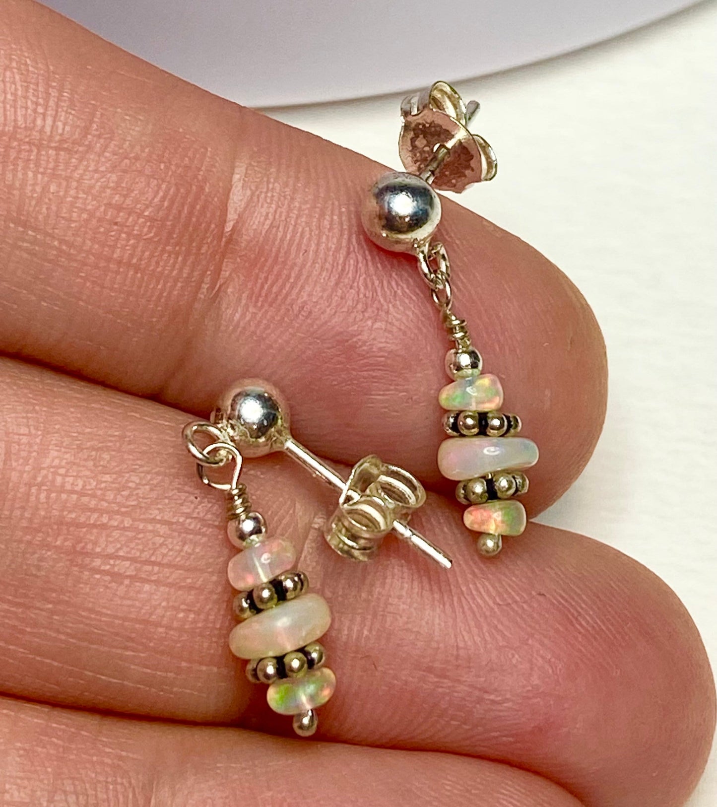 Sterling silver dangle earrings with natural Ethiopian Wello opals.