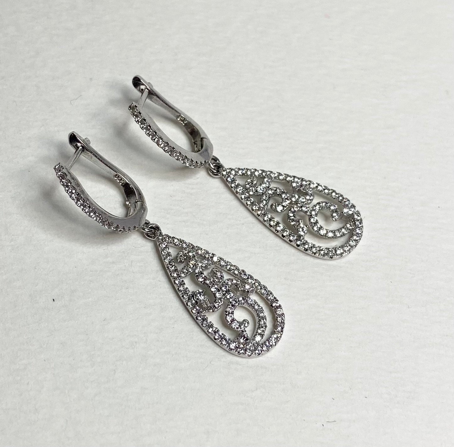 Sterling silver dangle earrings with pave cz stones in a tear shape.
