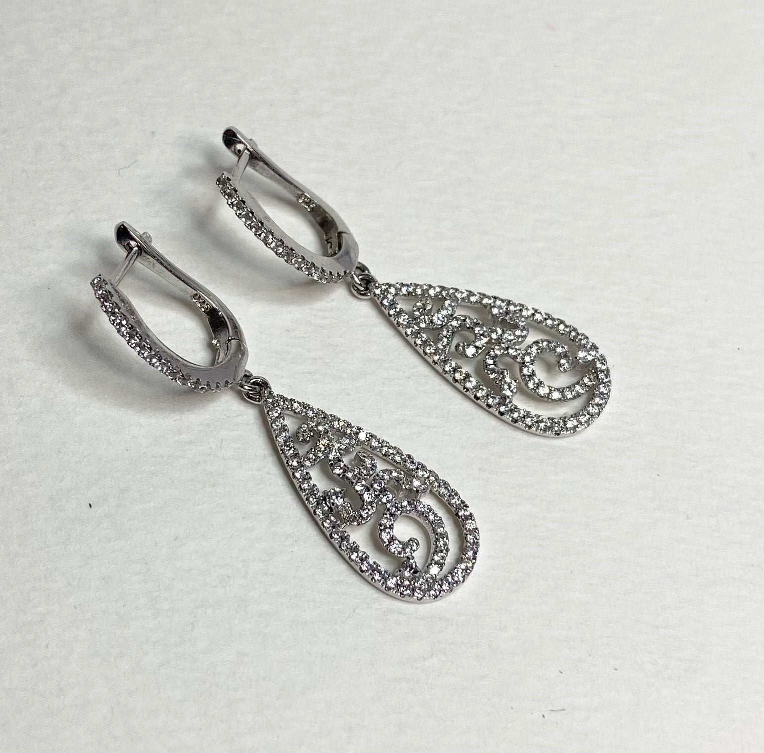 Sterling silver dangle earrings with pave cz stones in a tear shape.