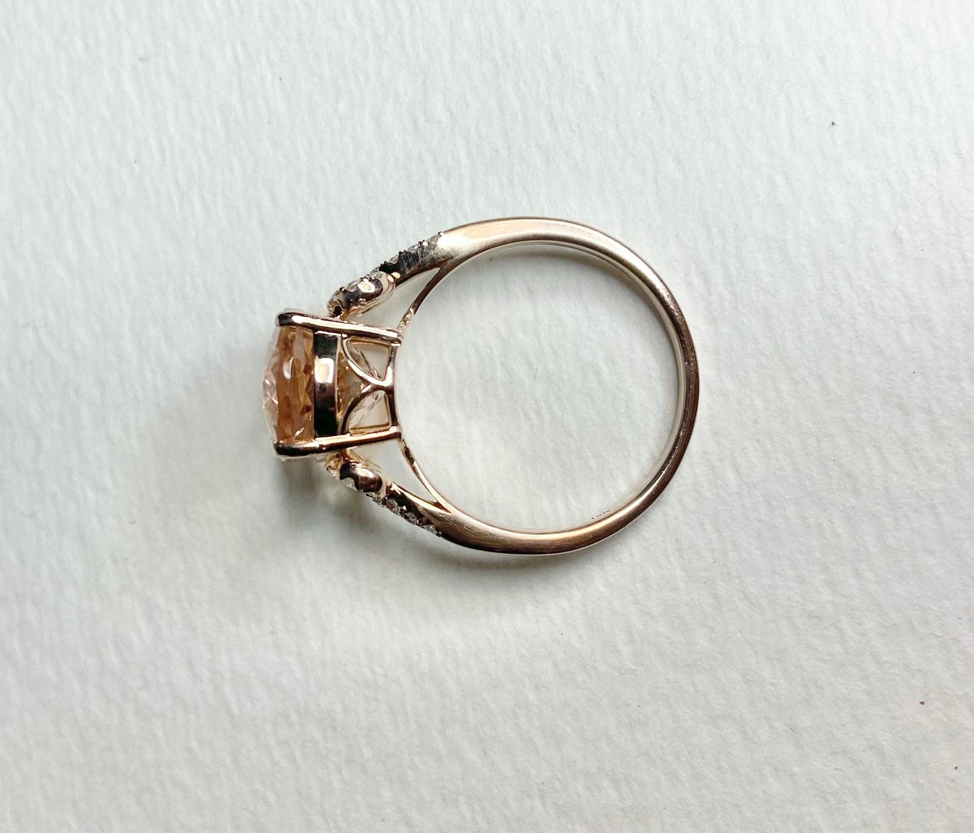 18k rose gold ring with oval morganite and diamond accents.