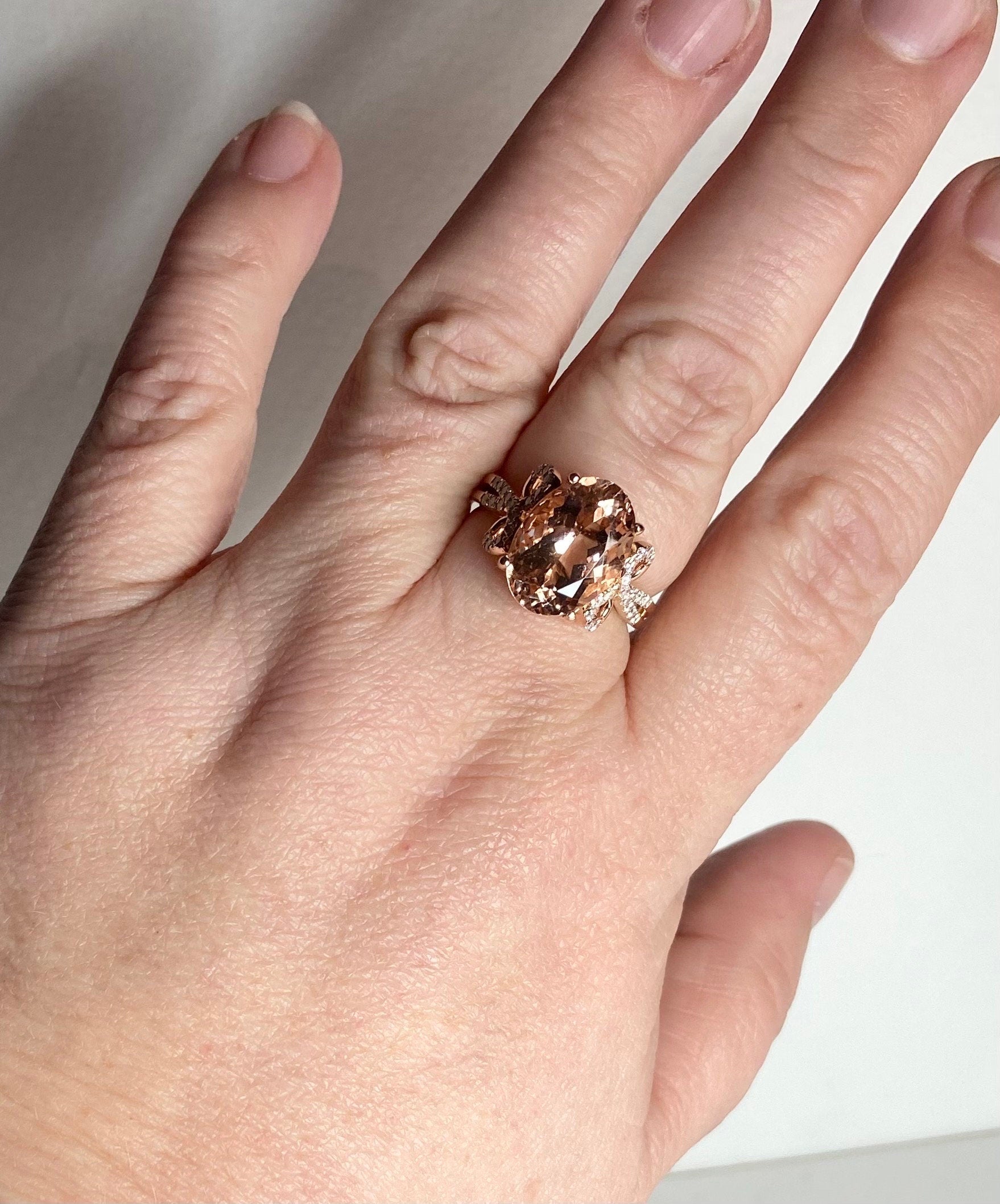 Oval morganite and diamond bow ring in rose gold.