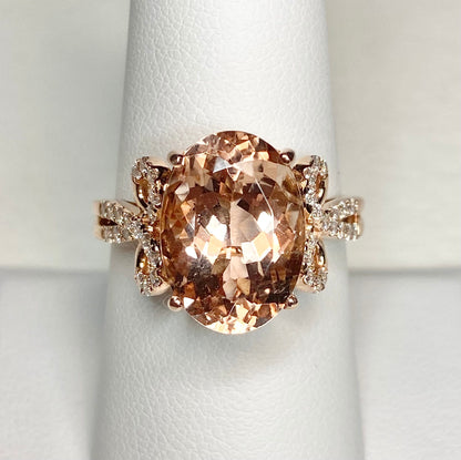 18k rose gold ring with oval morganite and diamond accents.