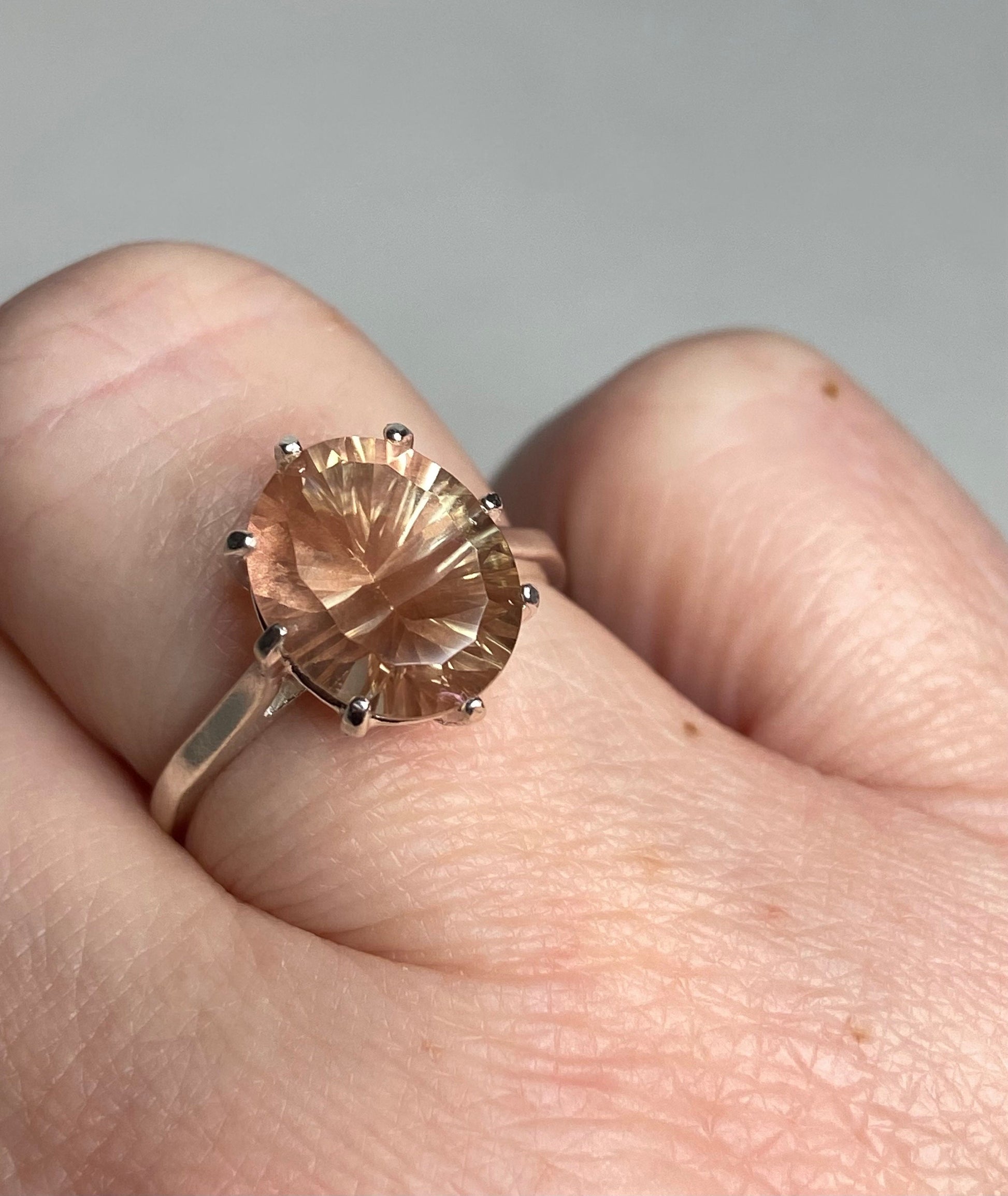 Sterling silver ring with a peach and green Oregon sunstone.