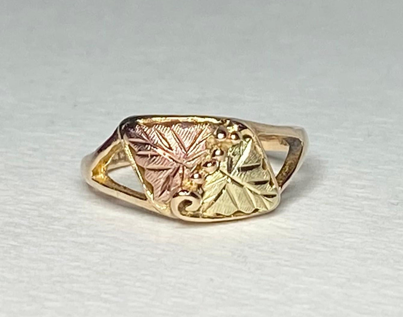 Black Hills Gold ring with two leaves and grape clusters.