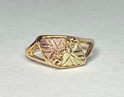 Black Hills Gold ring with two leaves and grape clusters.
