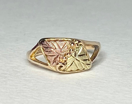 Black Hills Gold ring with two leaves and grape clusters.