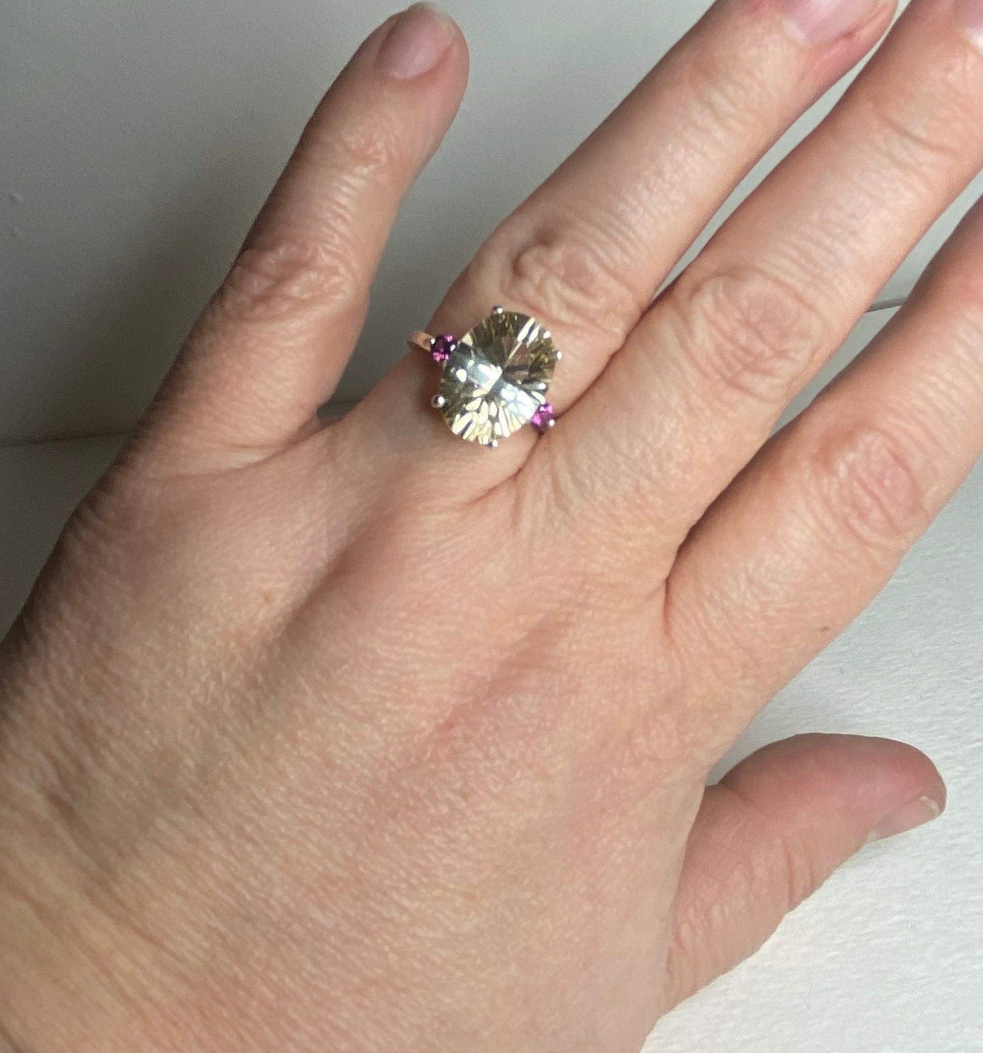 Oval Oregon sunstone ring with rhodolite garnets in sterling silver.