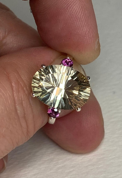 Sterling silver ring with a large oval Oregon sunstone and two Idaho rhodolite garnets.