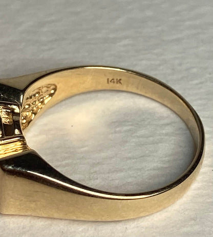 A solid 14k yellow gold ring with a bow design, marked 14K.