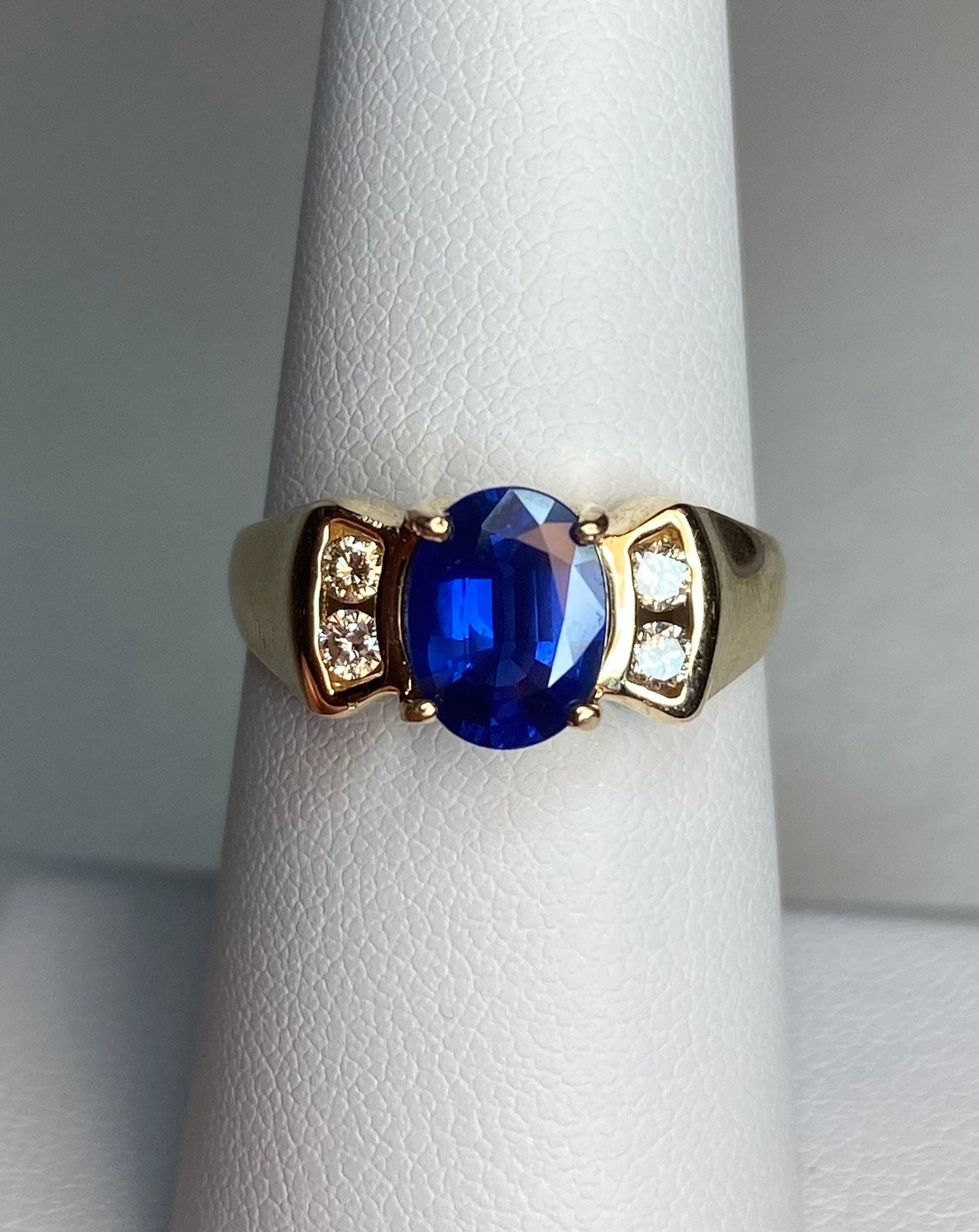14k yellow gold ring with a blue sapphire and diamonds.