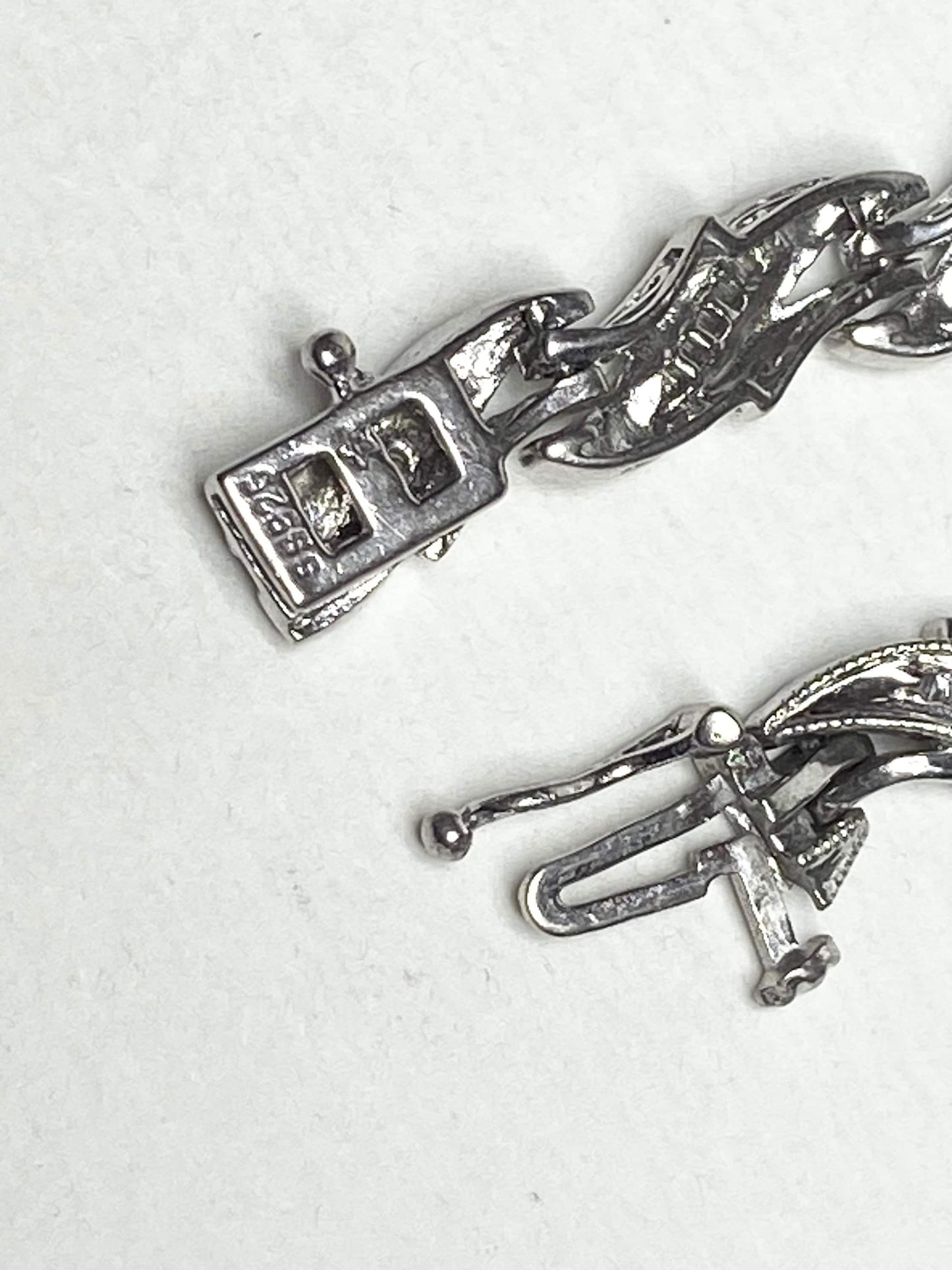 Rhodium plated sterling silver tennis bracelet with baguette diamonds.