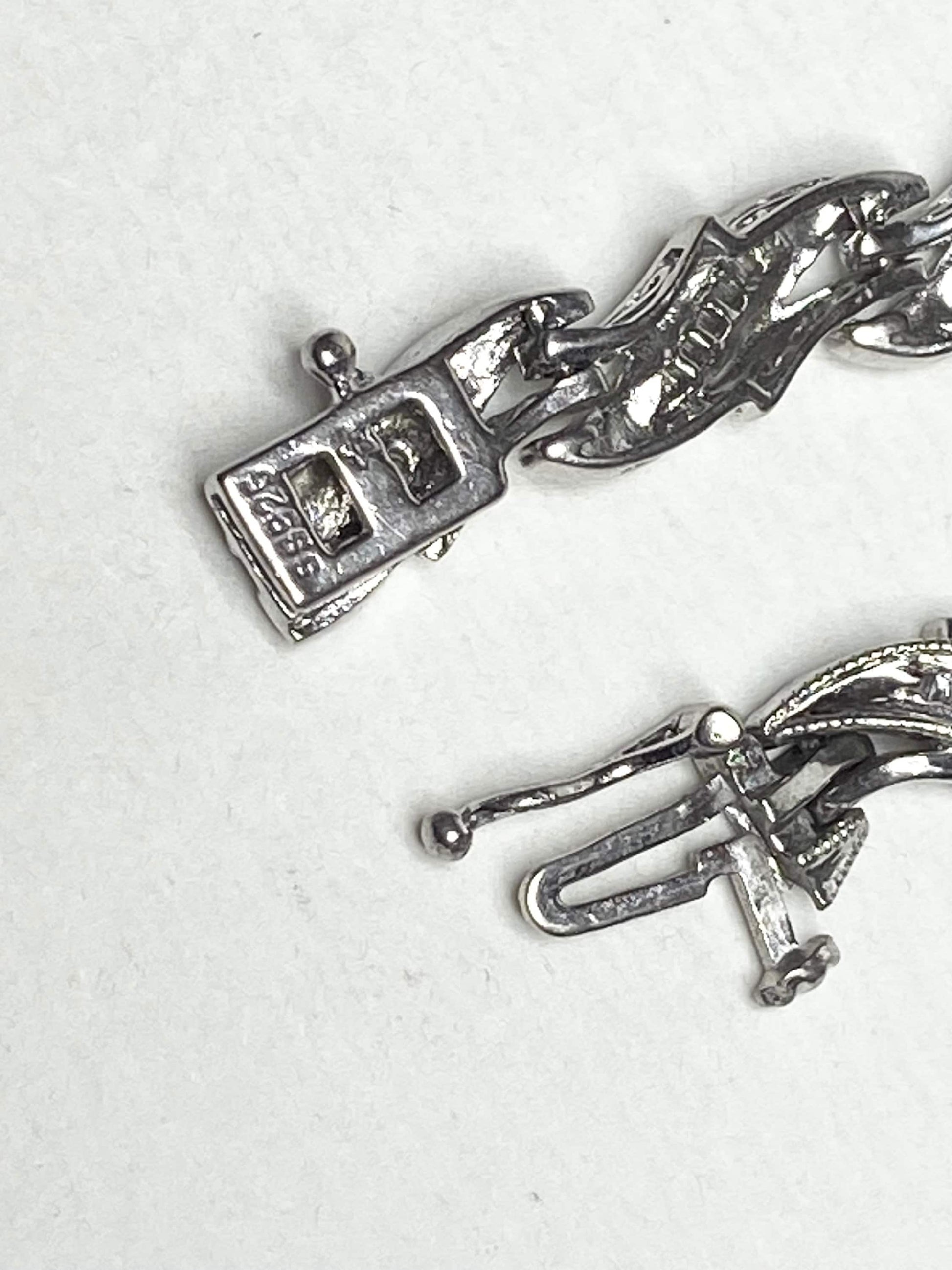 Rhodium plated sterling silver tennis bracelet with baguette diamonds.