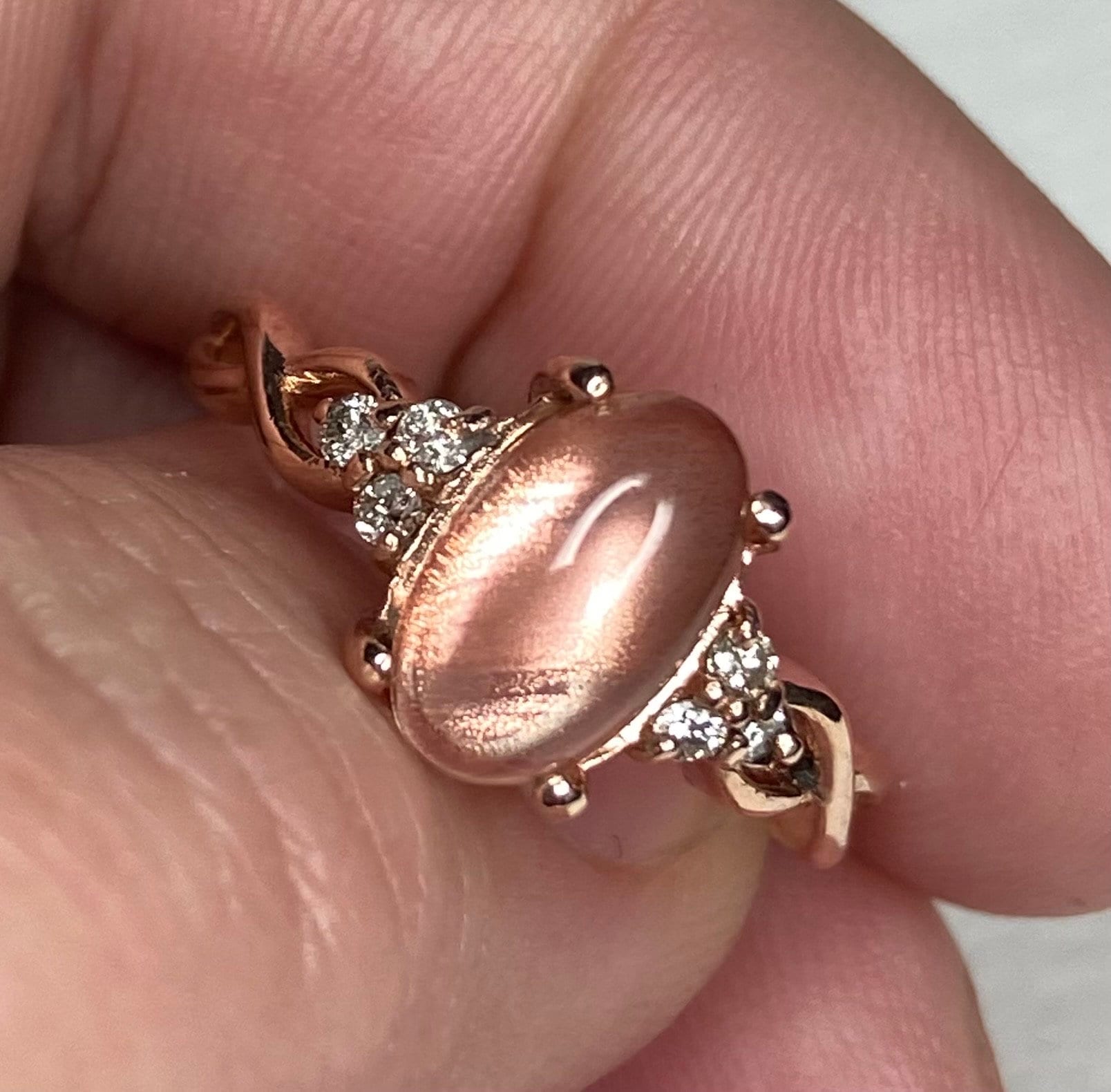 Oval Oregon sunstone and diamond ring in 10k rose gold.