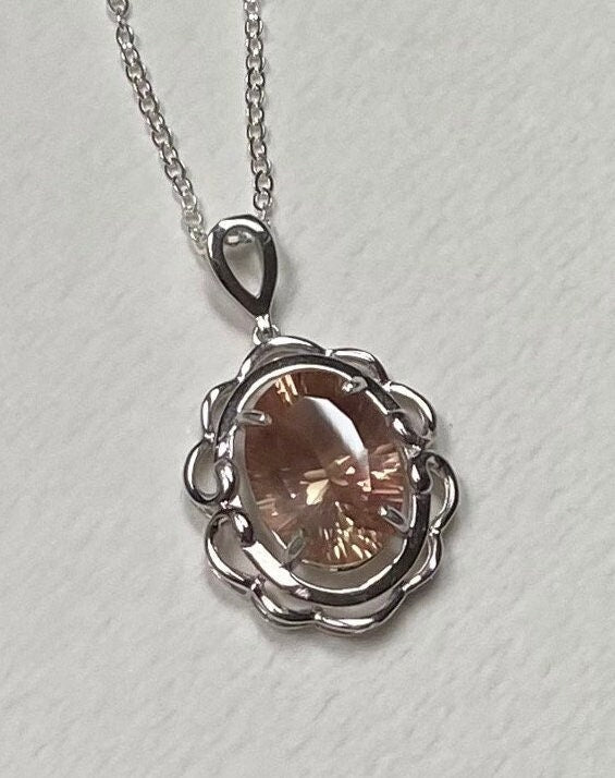 Oval fancy cut Oregon Sunstone pendant necklace in sterling silver.