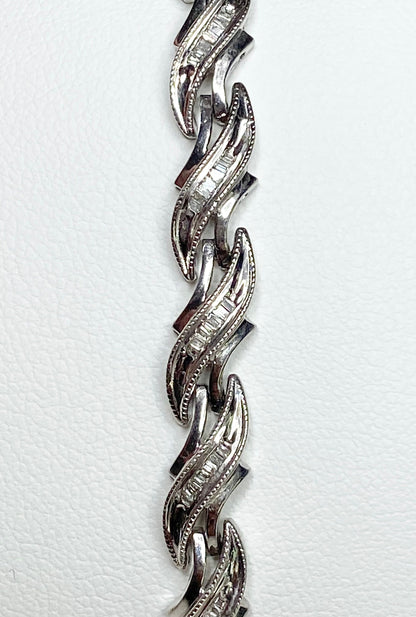 Rhodium plated sterling silver tennis bracelet with baguette diamonds.