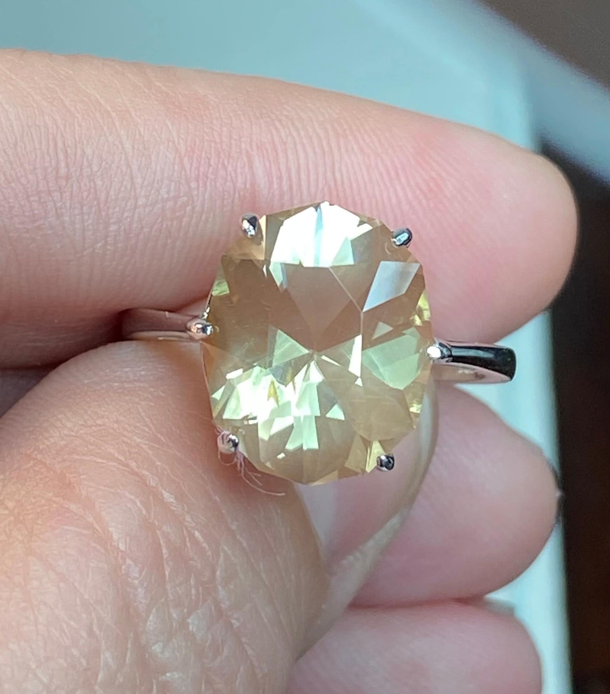 Large oval Oregon sunstone ring with a fancy cut in a sterling silver setting.