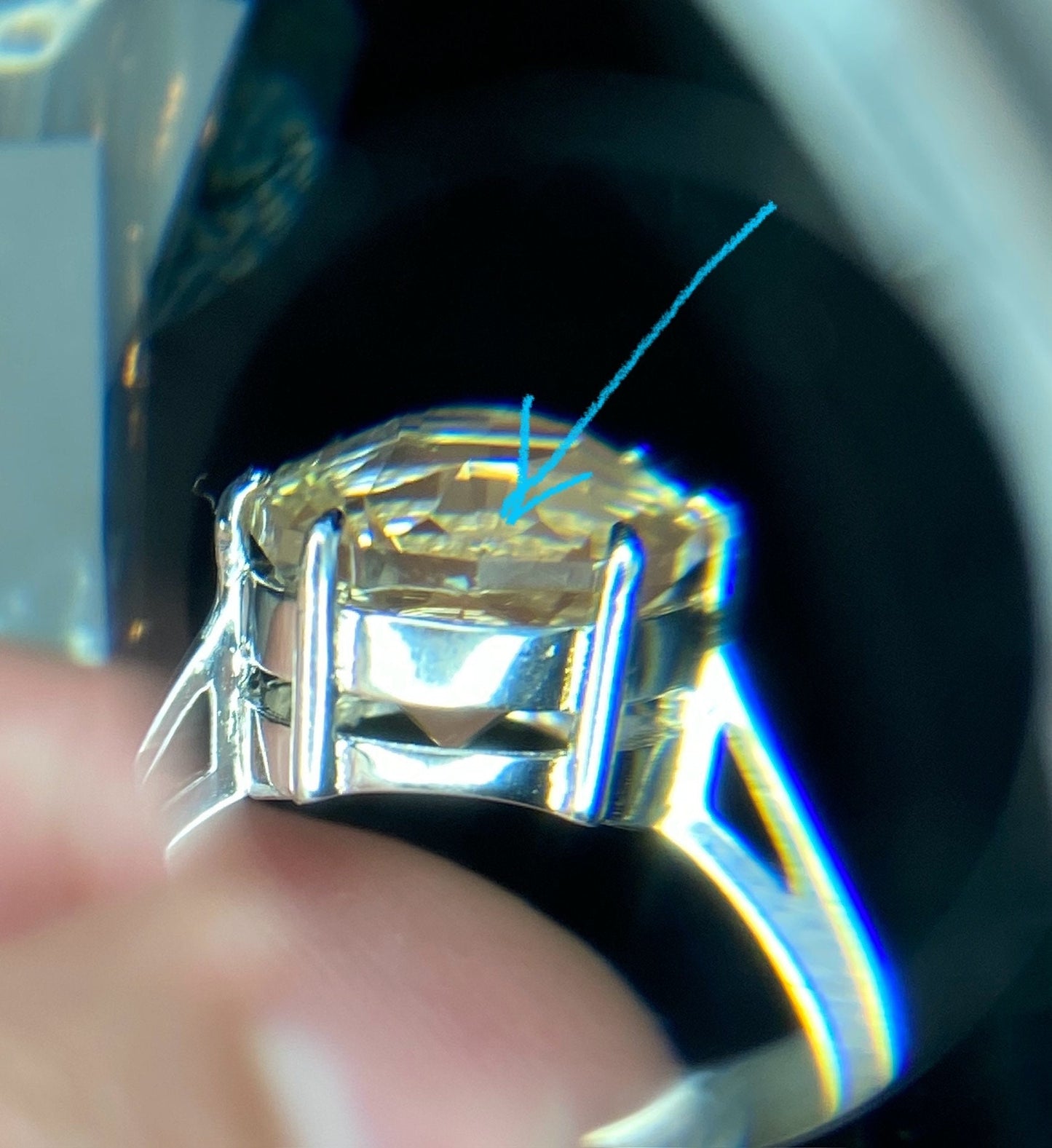 Ring with a large, fancy-cut Oregon sunstone in a silver setting.