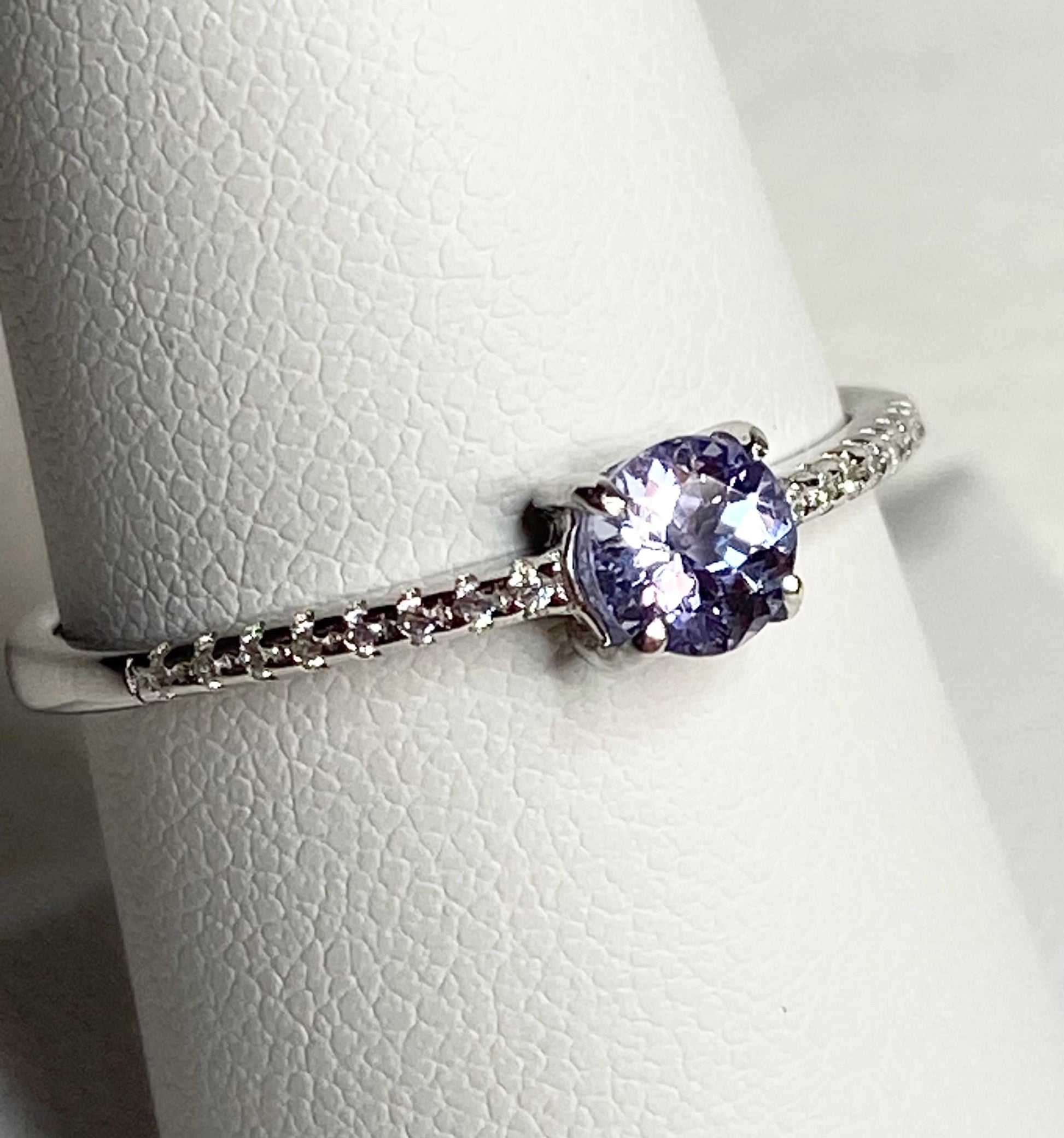 Sterling silver ring with a round tanzanite and small accent stones.