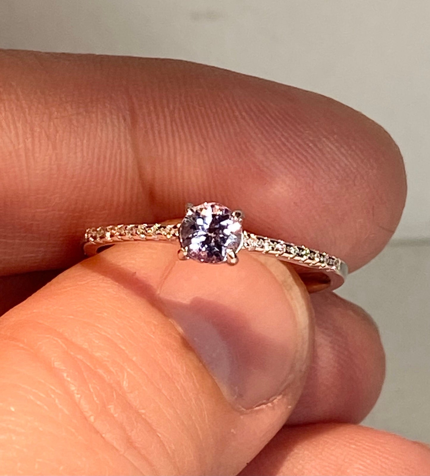 Sterling silver ring with a round tanzanite and small accent stones.