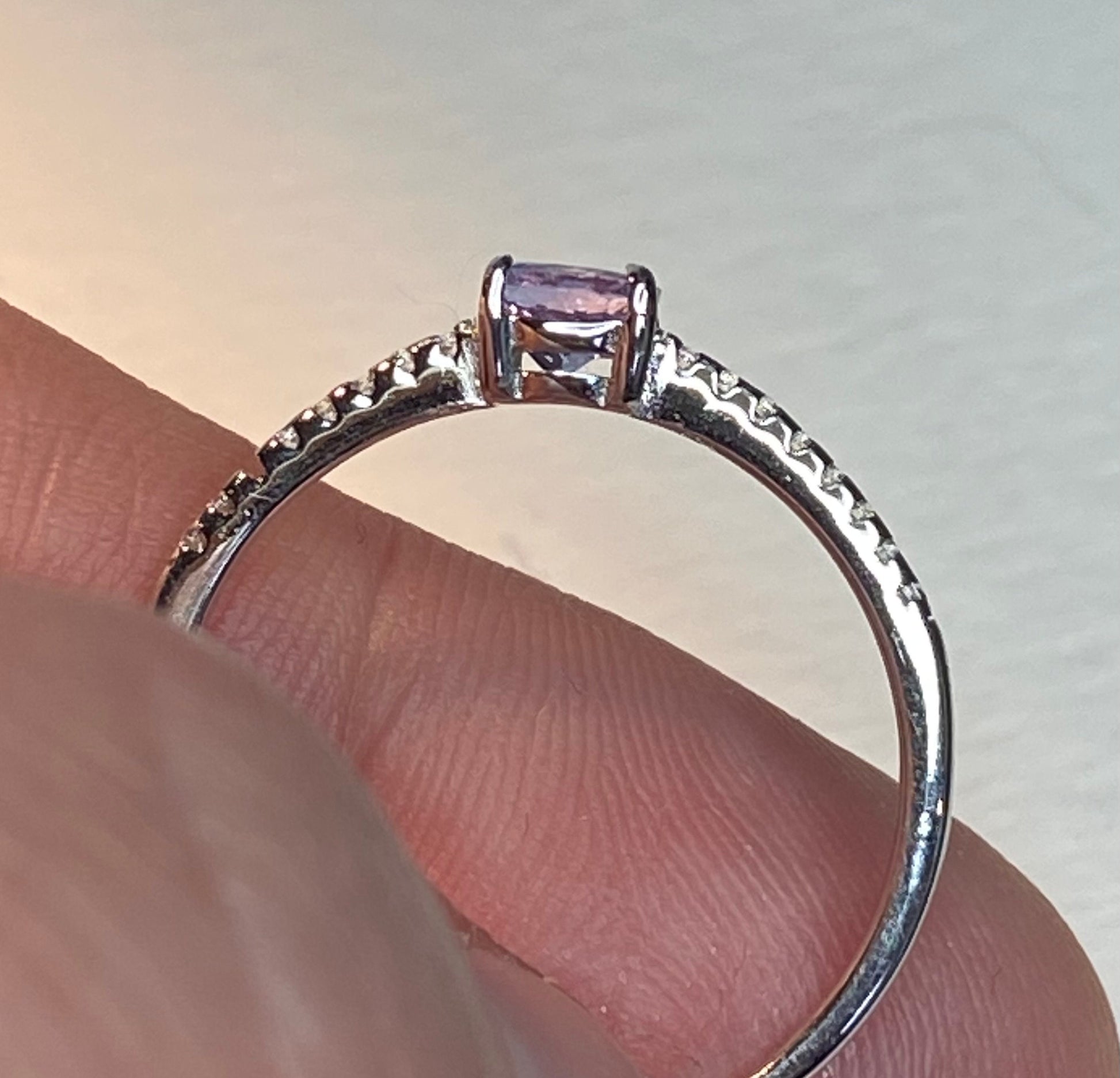 Sterling silver ring with a light violet tanzanite and tiny cz accents.