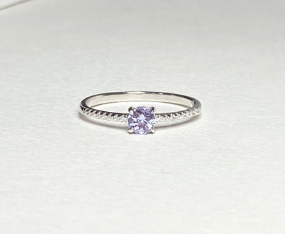Sterling silver ring with a round tanzanite and small accent stones.