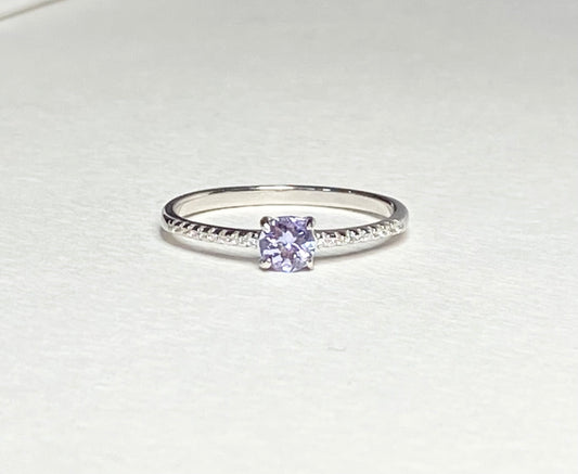 Sterling silver ring with a round tanzanite and small accent stones.