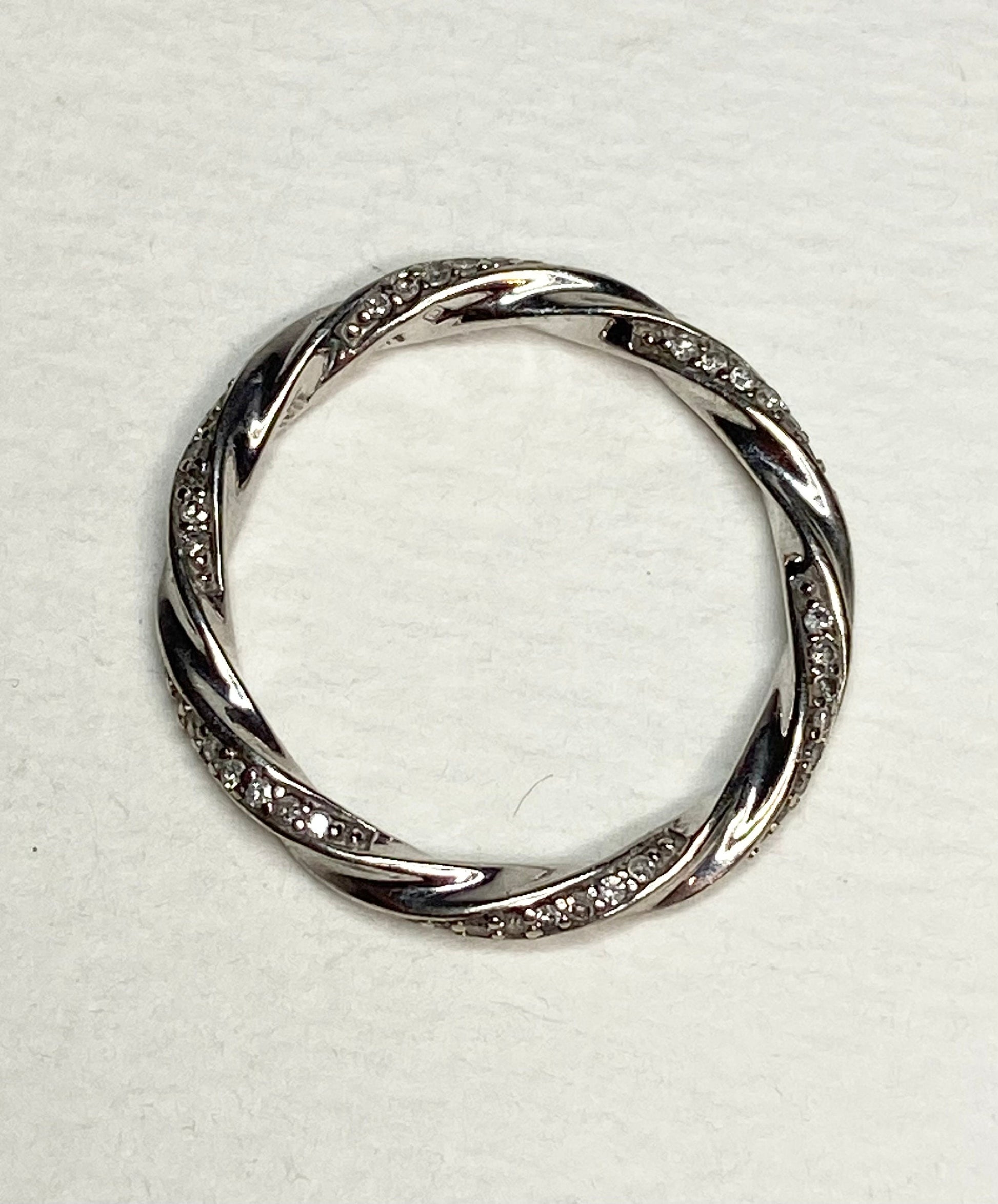 A twisted 10k white gold eternity band ring with 72 natural diamonds.