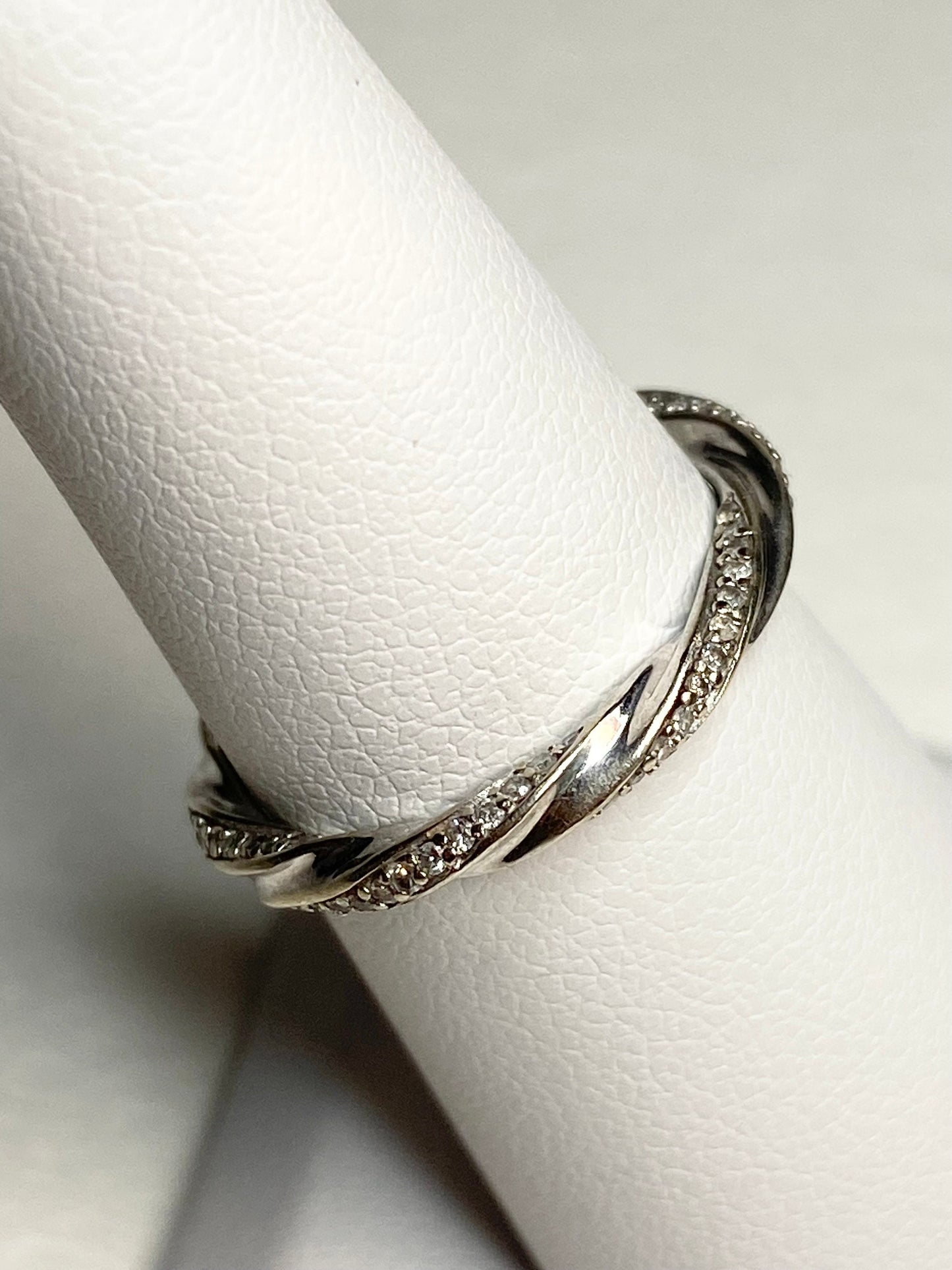 A 10k white gold eternity band with a twisted design and 72 natural diamonds.