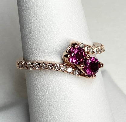 14k rose gold ring with two rhodolite garnets and diamonds.