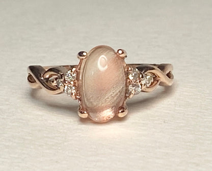 Oval Oregon sunstone and diamond ring in 10k rose gold.