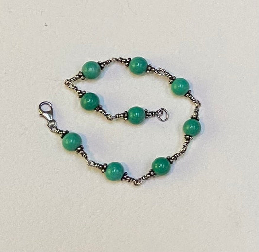 Sterling silver bracelet with round blue jasper beads and a lobster clasp.