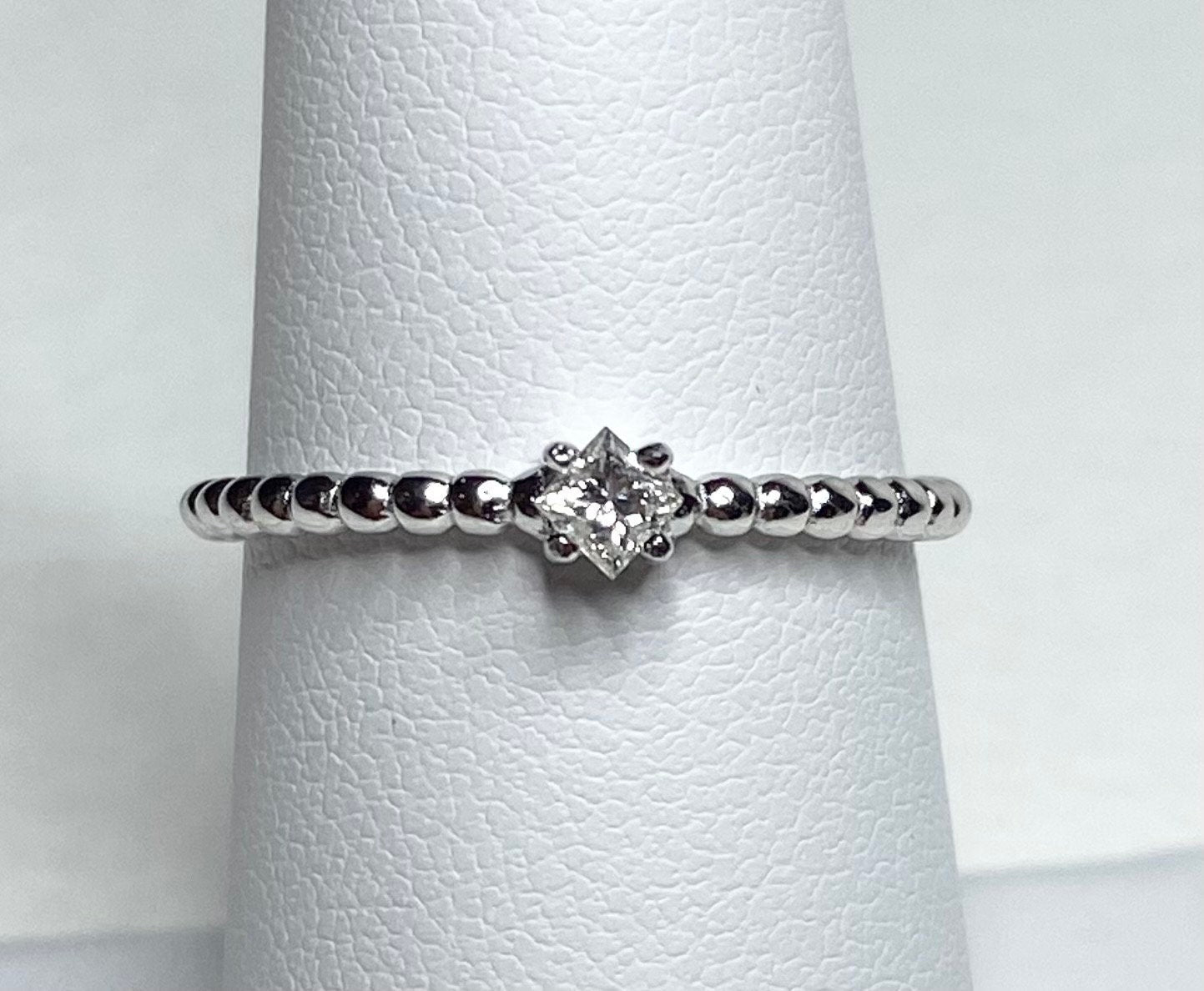 Natural princess cut diamond solitaire ring on a beaded sterling silver band.