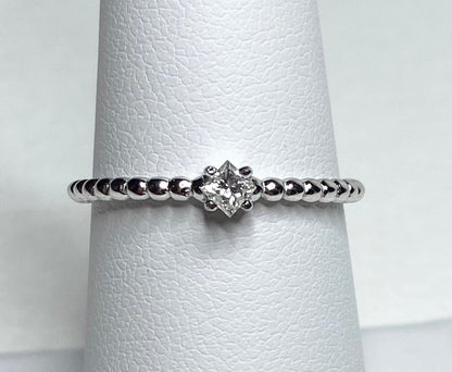 Natural princess cut diamond solitaire ring on a beaded sterling silver band.