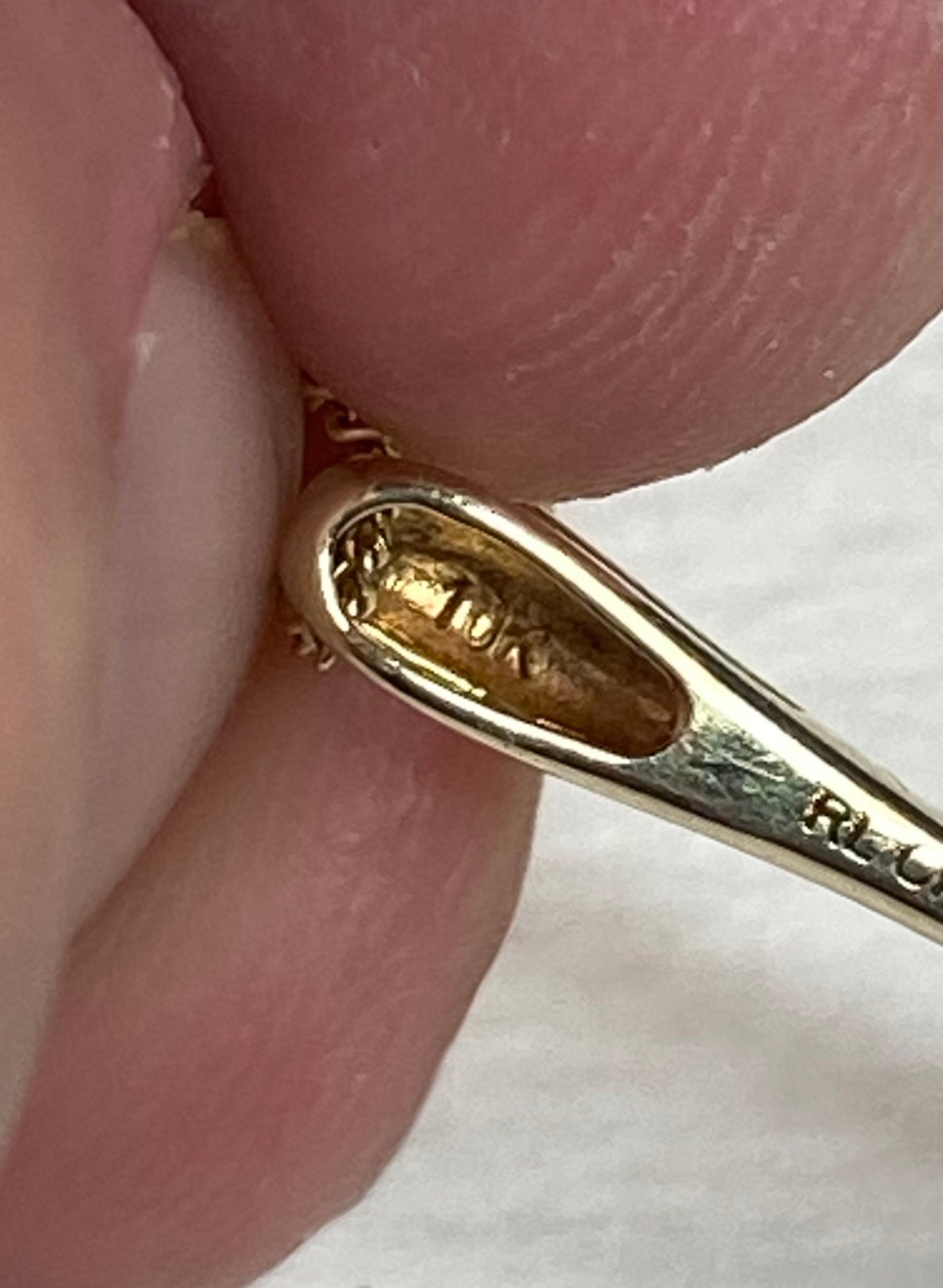 A 10k gold pendant with an aquamarine and diamonds.