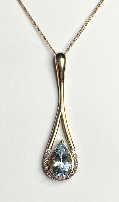 10k gold pendant with pear aquamarine and diamonds on a chain.