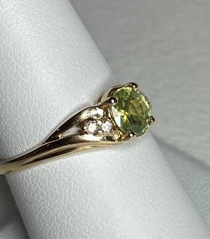 14k gold ring with a green tourmaline and two diamonds.