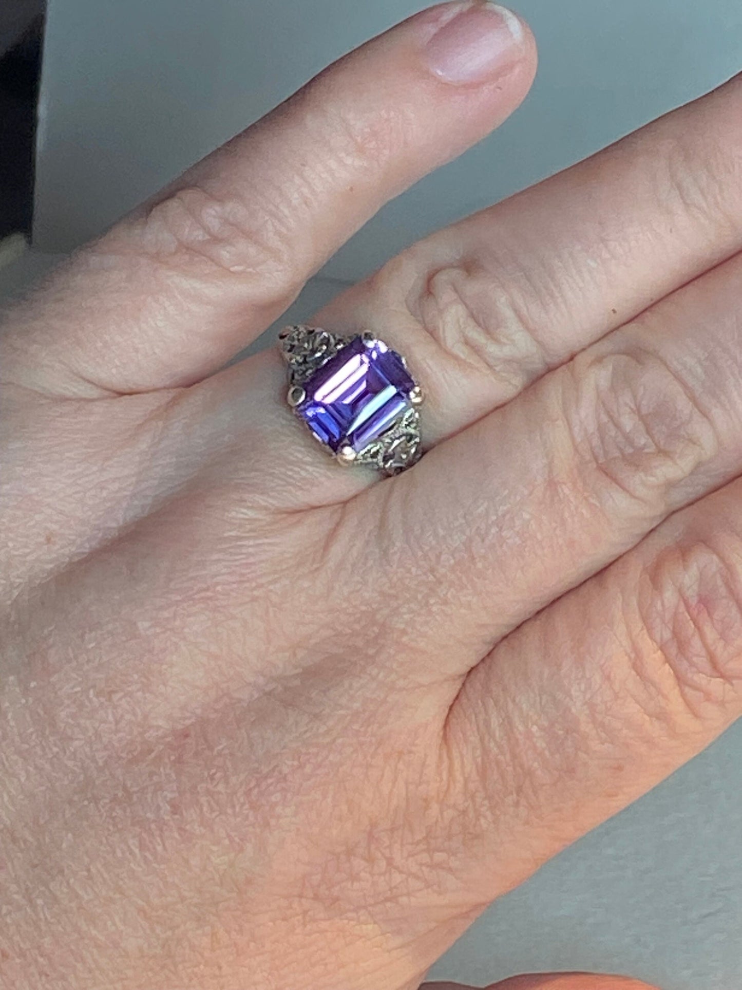 Art Deco ring with a color-changing sapphire and sterling silver filigree.