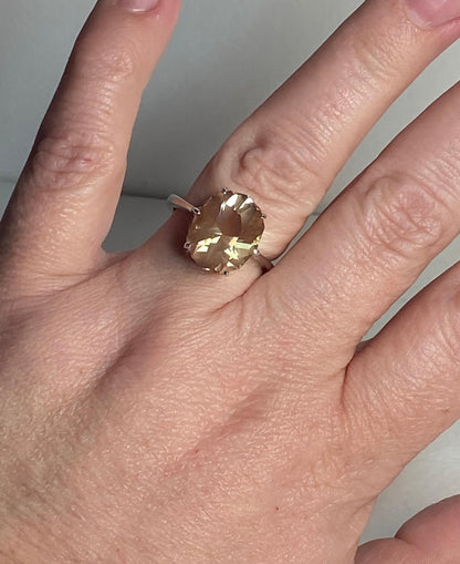 Oval Oregon sunstone ring with a fancy cut in a sterling silver setting.