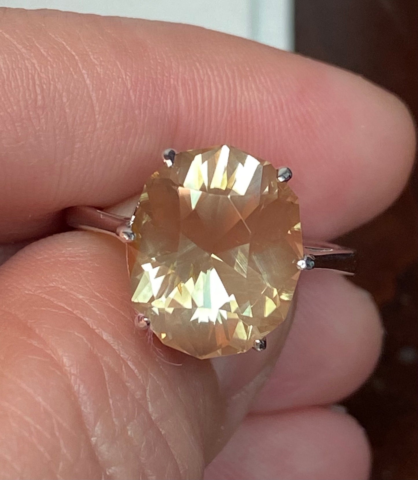 A large oval fancy cut Oregon sunstone ring in a sterling silver setting.