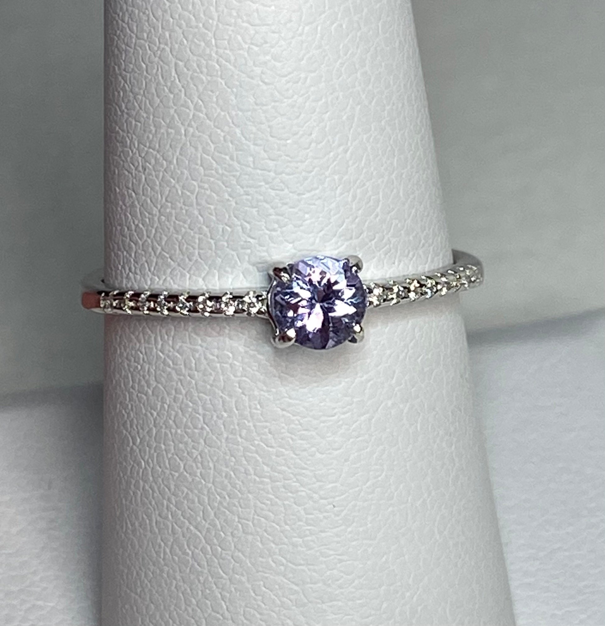 Sterling silver ring with a round tanzanite and small accent stones.