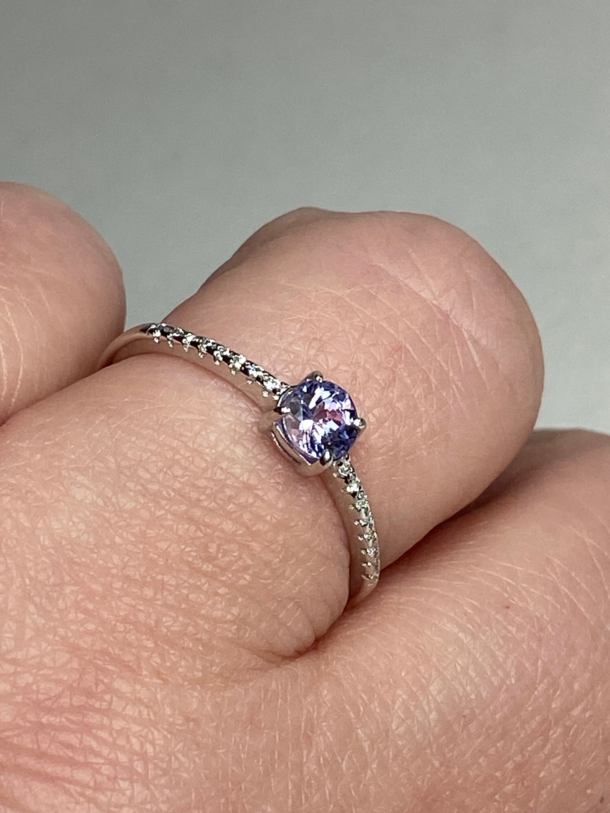 Sterling silver ring with a round tanzanite and small accent stones.