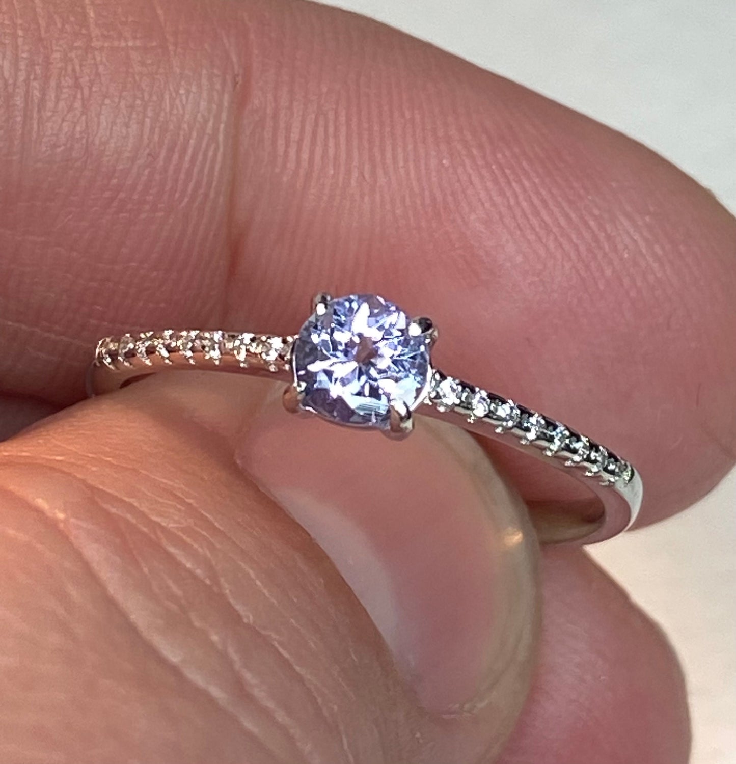 Sterling silver ring with a light violet tanzanite and small accent stones.